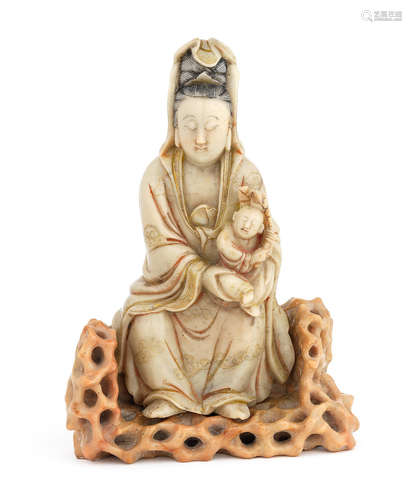 17th/18th century A soapstone figure of Guanyin seated on a rocky stand