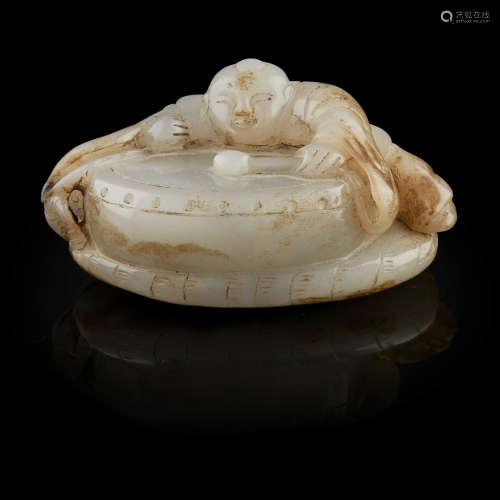 GREY JADE CARVING OF A BOY PLAYING A DRUM