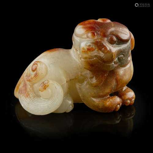 CELADON AND RUSSET JADE FIGURE OF A BUDDHIST LION CUB