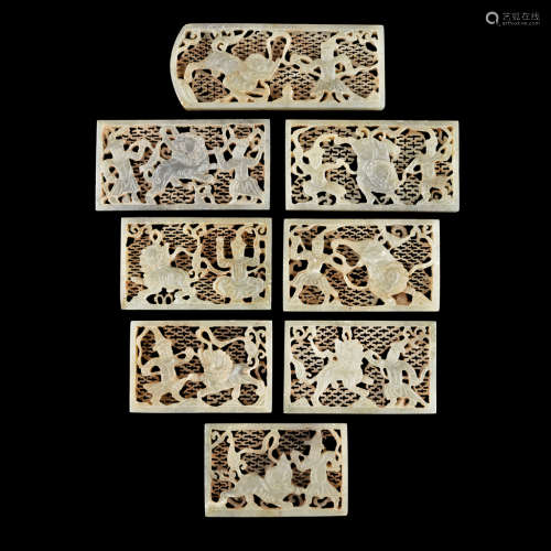 GROUP OF EIGHT CARVED AND PIERCED CELADON JADE BELT PLAQUES