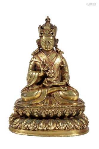 A Tibetan gilt bronze figure of Padmasambhava , 16-17th century