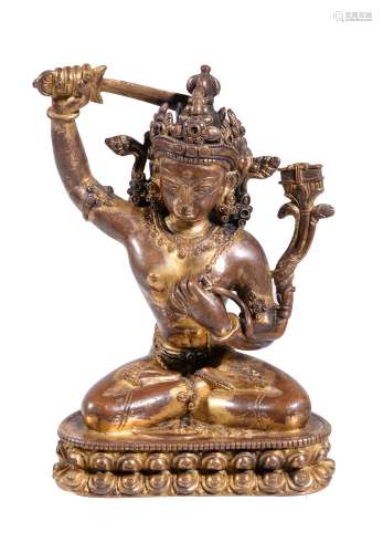 A gilt bronze figure of Manjusri, Nepal, seated in padmasana on a double...