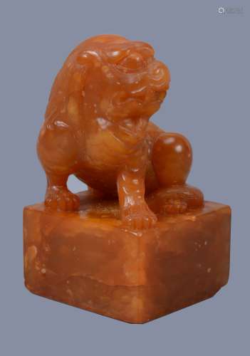 A Chinese Shoushan stone 'Buddhistic Lion' seal, seated on square seal base