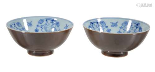 A pair of Chinese bowls, the interiors painted with blue and white with...