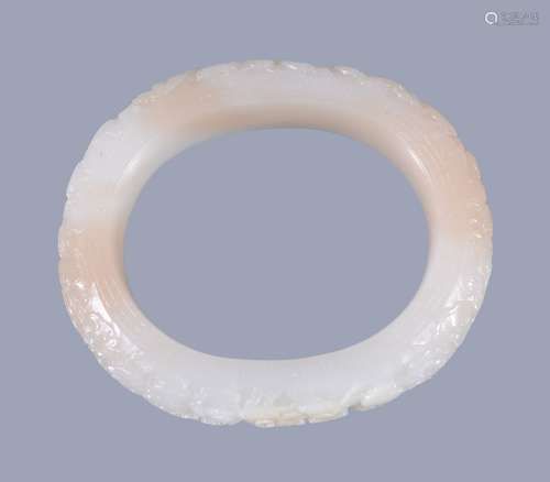 A Chinese white jade bangle, with some inclusions in light brown and white