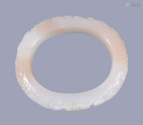 A Chinese white jade bangle, with some inclusions in light brown and white