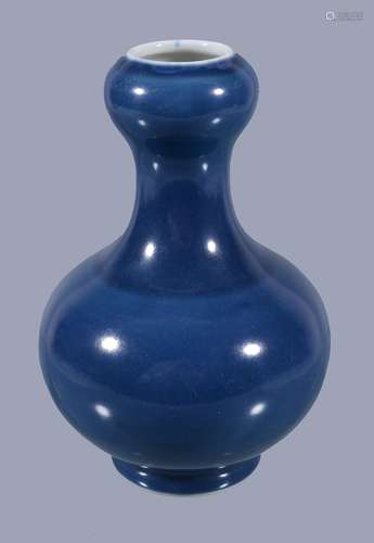 A Chinese blue monochrome vase, the ovoid body with garlic neck