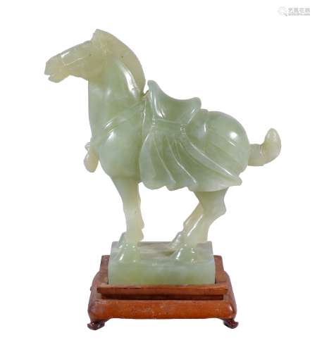 A Chinese celadon jadeite horse , in archaic style, standing with saddle, 16