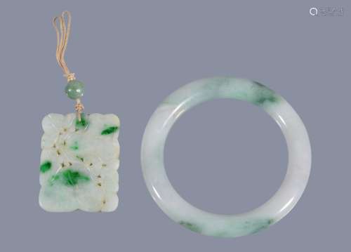 A Chinese jadeite bangle, with green inclusions, the bangle 8