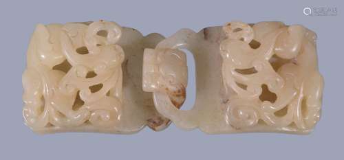 A Chinese pale celadon belt hook, in two sections and carved with chilong