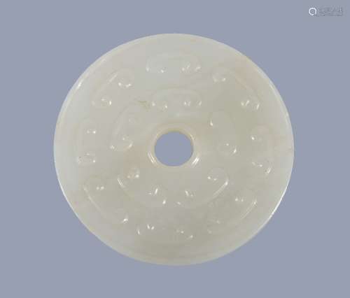 A Chinese white jade disc , bi , carved with scrolls, 5.2cm diameter Provenance
