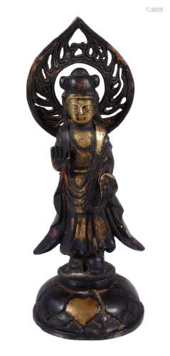 A Chinese parcel-gilt iron figure of Quanyin, standing on a circular lotus