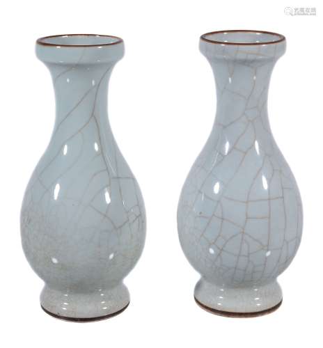 A pair of Chinese Guan type vases, with brown lines to the glaze