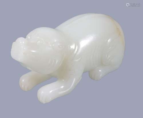 A Chinese white jade carving of a bear, recumbent with head looking forward, 7