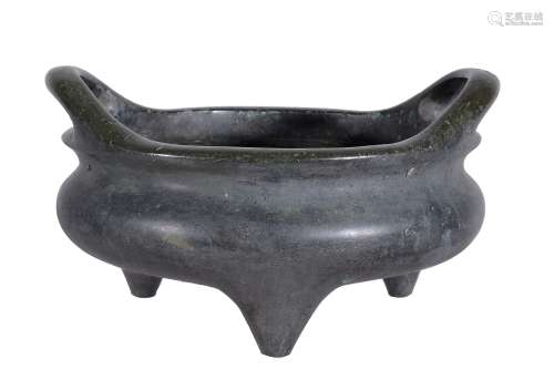 A Chinese bronze two-handled censer, supported on three feet