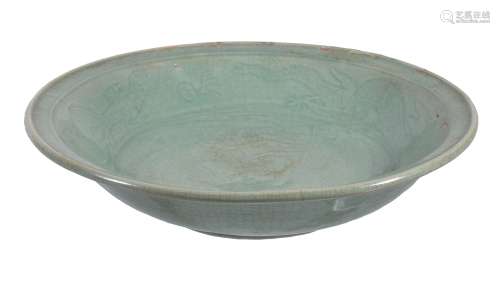 A large Longquan type celadon dish, incised beneath the green glaze with a...