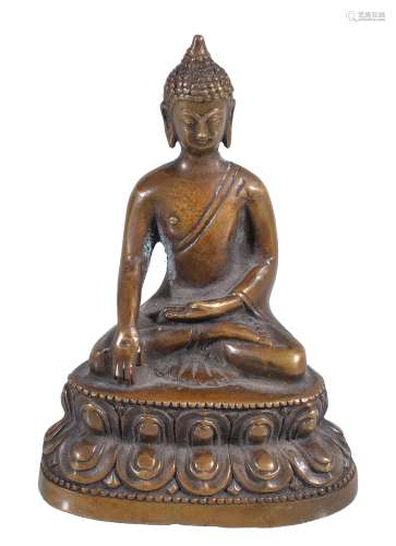 A Nepalese style small bronze Buddha, seated on a double lotus throne