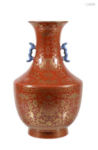 A Chinese coral-ground two-handled vase, painted in gilt with flower heads...