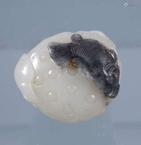 A Chinese white and black jade carving of a lotus pod