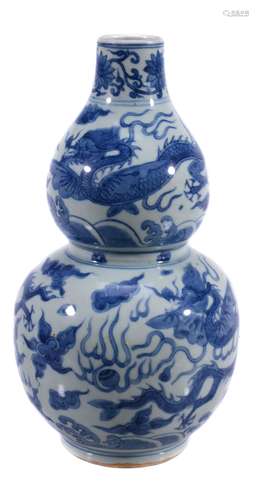 A Chinese Ming-style double gourd vase , painted with dragons chasing the...