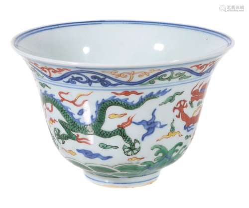 A Chinese Wucai 'dragon' bowl, painted in underglaze blue and white and...