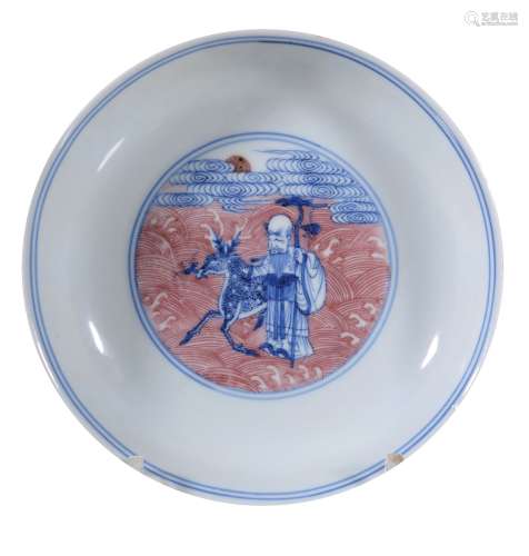 A small Chinese copper-red and blue and white ' Eight Immortals' saucer dish