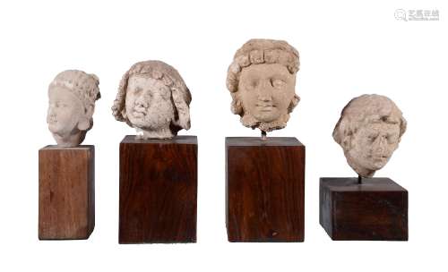 Four Gandhara stucco heads of Buddhist devotees, 4-5th century