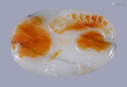 A Chinese white and russet jade horse buckle , carved as a reclining horse, 6