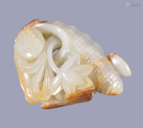 A Chinese pale celadon and russet 'shell and lotus' carving