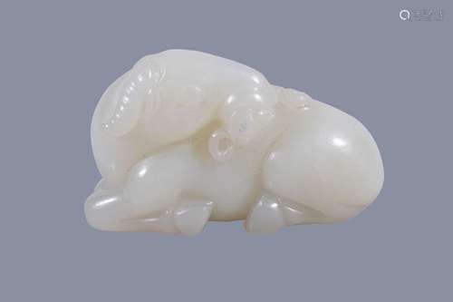 A Chinese white jade ram, well carved with its head turned back and holding...