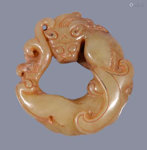 A Chinese celadon and russet carved jade chilong , 4.6cm diameter Provenance