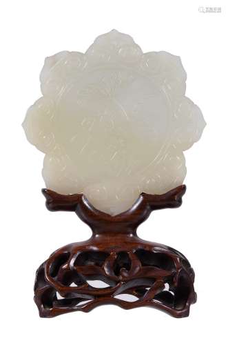A Chinese white jade flower plaque, carved on one side with lilies and the...