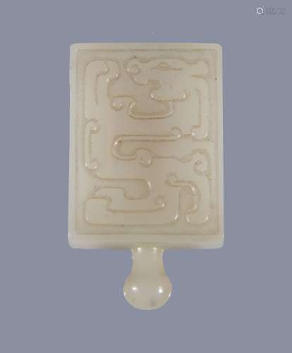 A Chinese white jade buckle, carved with archaic designs, 4.5cm high Provenance