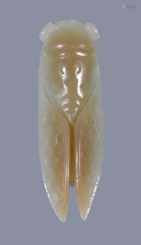 A Chinese celadon and russet jade cicarda , 6.5cm long Provenance