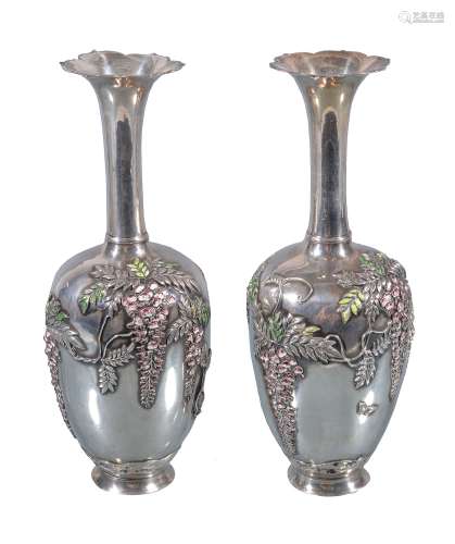 A Pair of Japanese Silver Vases each of ovoid form resting on a splayed foot...