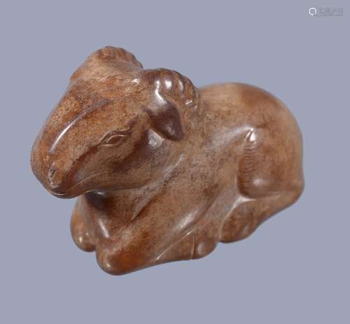 A Chinese brown jade ram, recumbent with legs tucked underneath its body