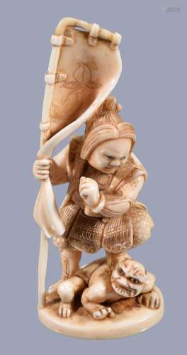 Ω A Japanese ivory Okimono depicting a youthful Shoki standing