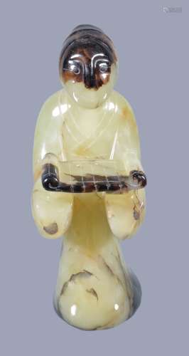A Chinese yellow jade figure, 20th century, standing holding a tray