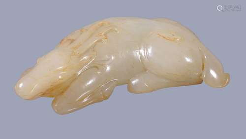 A Chinese white jade carving of a deer, with russet inclusions