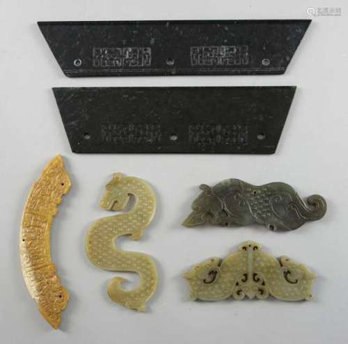 Three flat carved green jade animals, comprising a dog pendant, 12cm wide, two-headed dragon pendant, 11cm wide, and a dragon, 11.5cm wide, a yellow/brown jade carved arc pendant, 14cm wide, and two pieces of flat spinach jade with carved decoration,