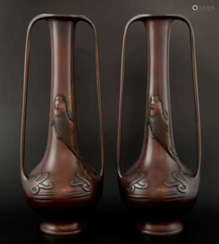 Pair of Japanese patinated bronze vases cast with Koi carp and stylised waves, 35cm high,