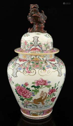 Chinese famille rose jar and cover decorated with a lion and flowers and foliage, the cover with temple lion finial, 36cm high,