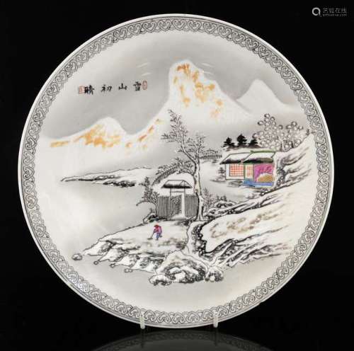 20th century Chinese porcelain plate decorated with a figure sweeping in a winter landscape, with calligraphy and two red seal marks, stamped four character mark to base, 25cm diameter,