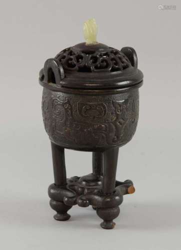 Chinese bronze tripod censer with stylised moulded decoration, pierced wooden cover and jade handle, 20cm high,