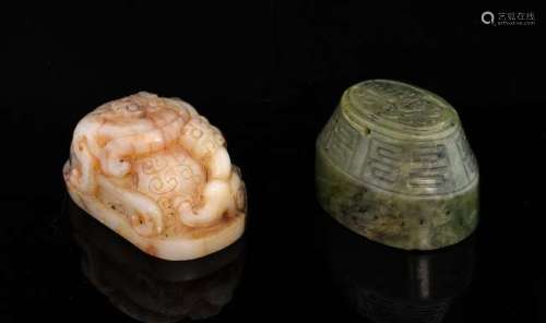 Chinese white and brown mottled uncut jade seal, carved with dragons, 7cm wide, and an oval uncut spinach jade seal carved with a dragon in low relief and geometric pattern, 6cm wide, (2),