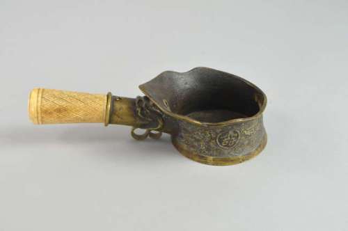 Chinese bronze libation cup with moulded decoration and charcters, with bone handle, overall length 25cm,
