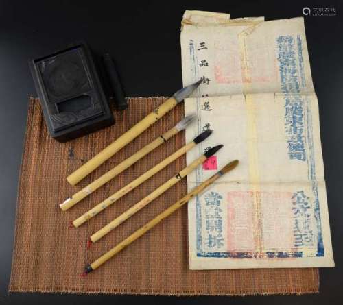 Five Chinese bamboo handled brushes, print role, pallet in hard wood case and three pieces of printed calligraphy,