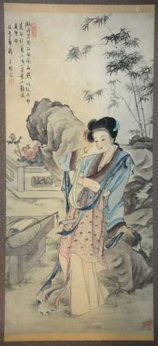 Chinese scroll painting depicting a lady seated on a rock in a garden, with calligraphy and two red seal marks, framed, 132cm x 61cm,