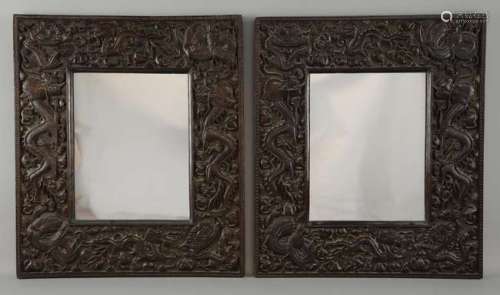 Pair of Chinese hardwood framed mirrors carved with dragons, each 50cm x 43.5cm,