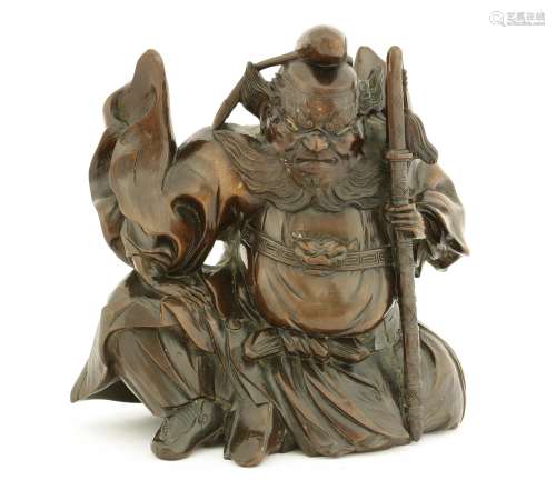 A Japanese hardwood carving of Shoki, Meiji period (1868-1912), the king of ghosts seated with his ...